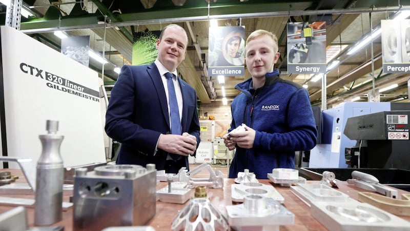 Economy Minister Gordon Lyons with Northern Regional College student David McMullan, who is taking part in the World Skills national final in CNC milling later this year. Picture: Kelvin Boyes/Press Eye 