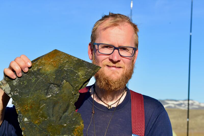 Jakob Vinther at the Sirius Passet locality North Greenland with specimen of Timorebestia (Dr Jakob Vinther/University of Bristol)