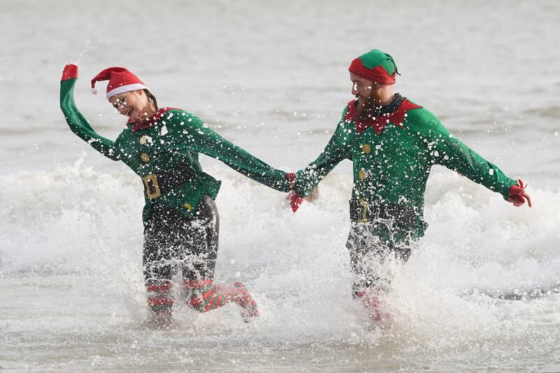 Swimmers take part in the Folkestone Lions’ Boxing Day Dip at Sunny Sands Beach in Folkestone, Kent