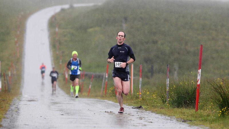 Runners brave wind and rain at the 10k run over Divis Mountain in July Picture by Cliff Donaldson 