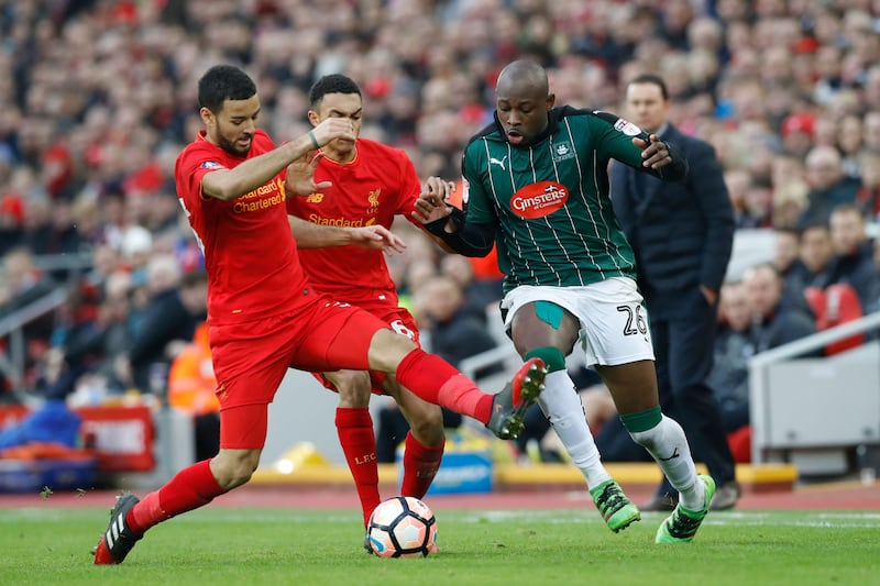 Liverpool's Trent Alexander-Arnold (centre) and Liverpool's Kevin Stewart (left) battle for the ball &nbsp;with Plymouth Argyle's Paul Arnold Garita&nbsp;