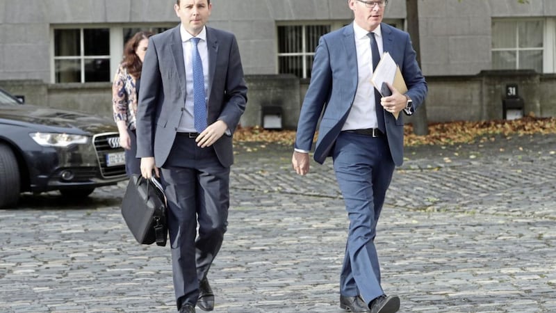 The Republic&#39;s minister for foreign affairs Simon Coveney, right, and his press advisor Chris Donoghue arrive at Government Buildings in Dublin, for a Brexit briefing. Picture by Niall Carson, Press Association 