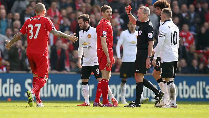 Liverpool's Steven Gerrard (centre) is shown the red card by referee Martin Atkinson during the Barclays Premier League match against Manchester United at Anfield, Liverpool on Sunday March 22, 2015. Picture by Peter Byrne/PA Wire