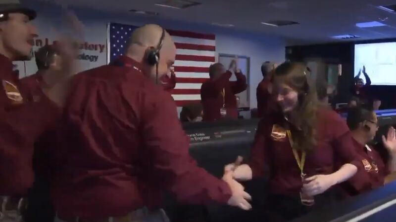 Two members of Nasa’s Jet Propulsion Laboratory celebrated the achievement with an impressive handshake.
