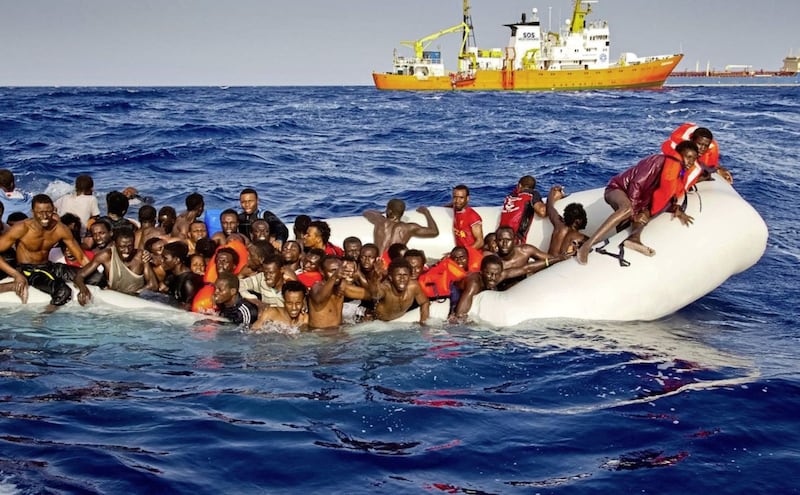 In this photograph, taken last April, migrants ask for help from a dinghy as they are approached by the SOS Mediterranee&#39;s ship Aquarius off the coast of Lampedusa. 