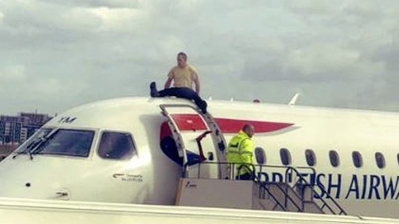 Paralympian James Brown sitting on top of a British Airways plane at City Airport, London. 