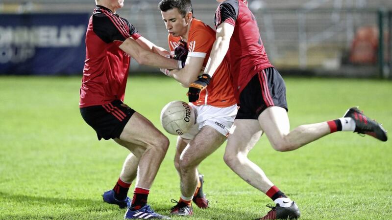 Armagh&#39;s Edward Mallon tangles with Down duo James Guinness and Cormack McCartan Picture by Declan Roughan 