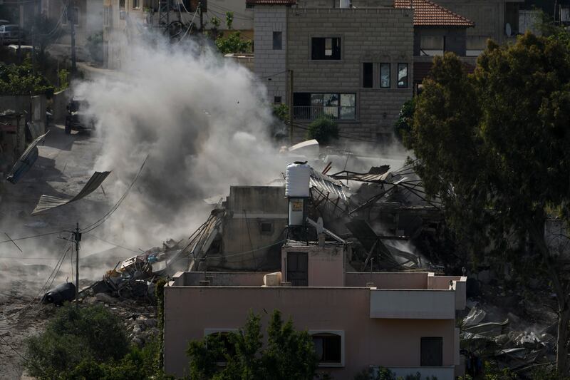 Smoke rises following an explosion during an Israeli military raid in the town of Deir al-Ghusun, near the West Bank town of Tulkarem (Majdi Mohammed/AP)