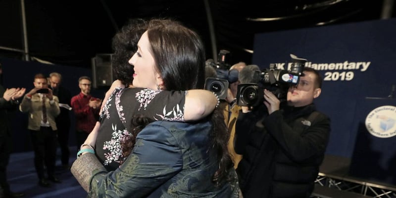 The SDLP&#39;s Claire Hanna embraces DUP candidate Emma Little-Pengelly after winning the Belfast South seat at the Titanic exhibition centre. 