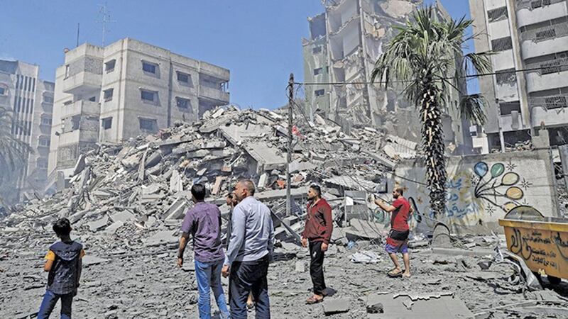 People inspect the the rubble of the Yazegi residential building that was destroyed by an Israeli airstrike, in Gaza City on Sunday. (AP Photo/Adel Hana). 