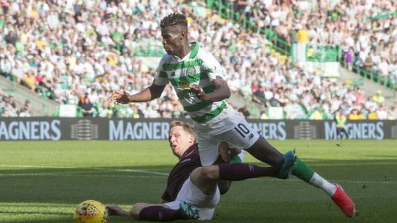 Vakoun Bayo of Celtic goes down under a challenge from Christophe Berra of Hearts.&nbsp;