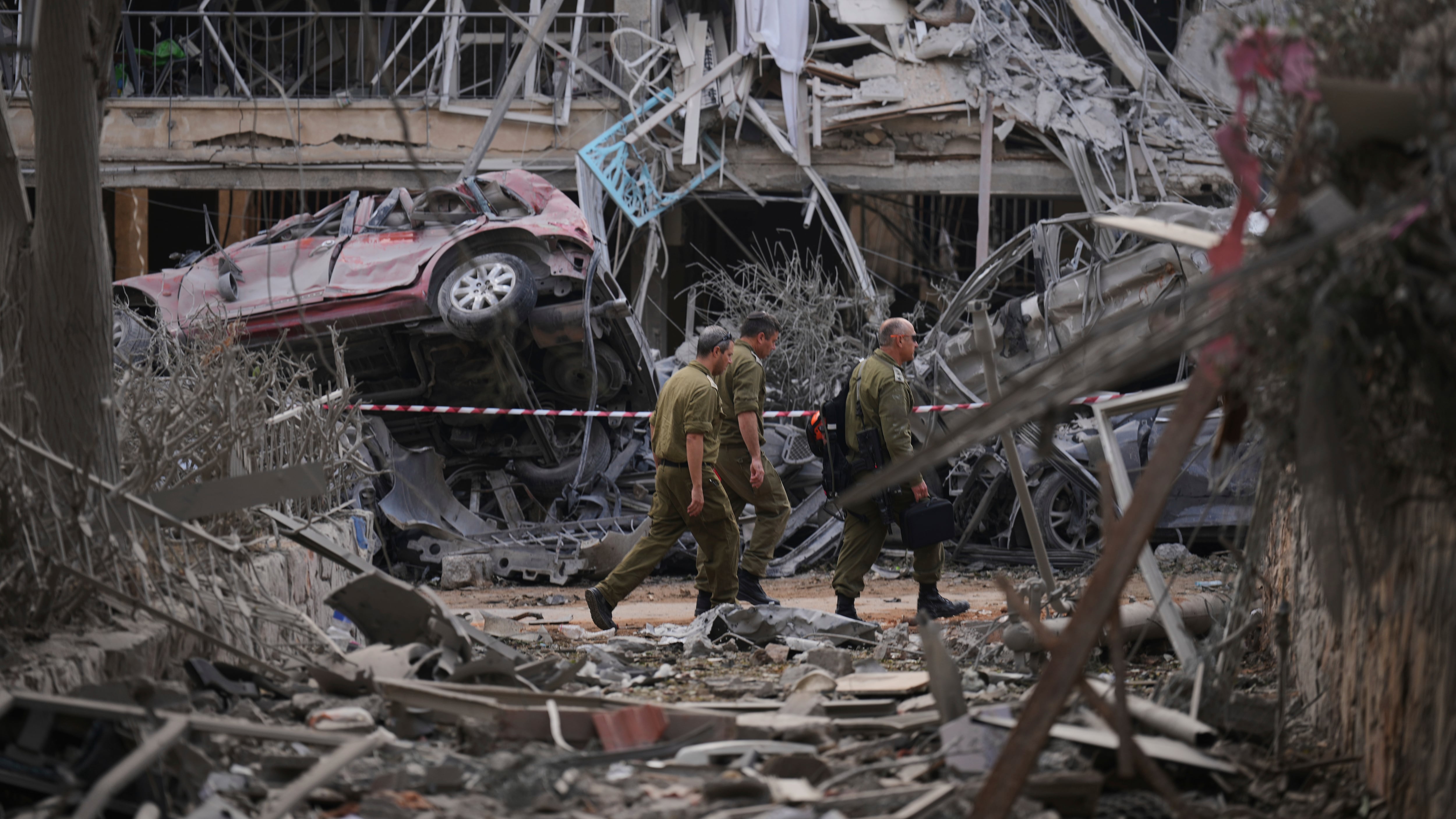 Israeli security forces inspect destroyed residential buildings near Tel Aviv (Ariel Schalit/AP)