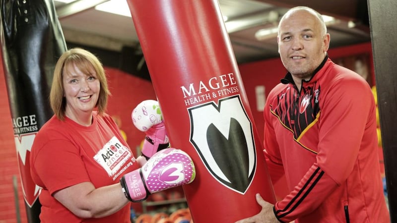 Boxer Brian Magee with Action Cancer ambassador Sandra McCarry who was diagnosed through the charity&#39;s breast screening service 
