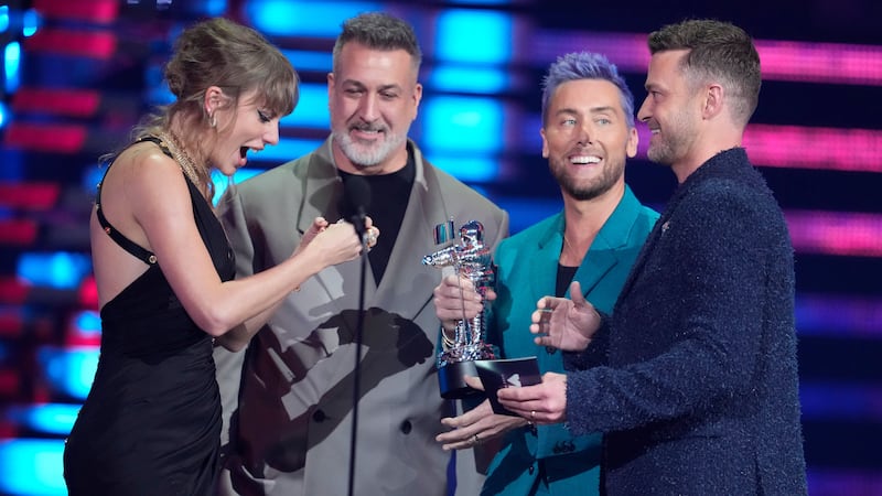(from centre) Joey Fatone, Lance Bass and Justin Timberlake of NSYNC present the award for best pop to Taylor Swift (far left) (Charles Sykes/AP/PA)
