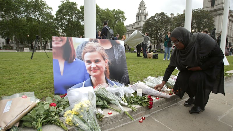 <span style="font-family: &quot;ITC Cheltenham&quot;; font-size: 8.5px;">People leave tributes to Labour MP Jo Cox at Westminster. Identity politics is always poisonous, even in relatively peaceful England where Mrs Cox was murdered by a far-right extremist outside her West Yorkshire surgery</span>