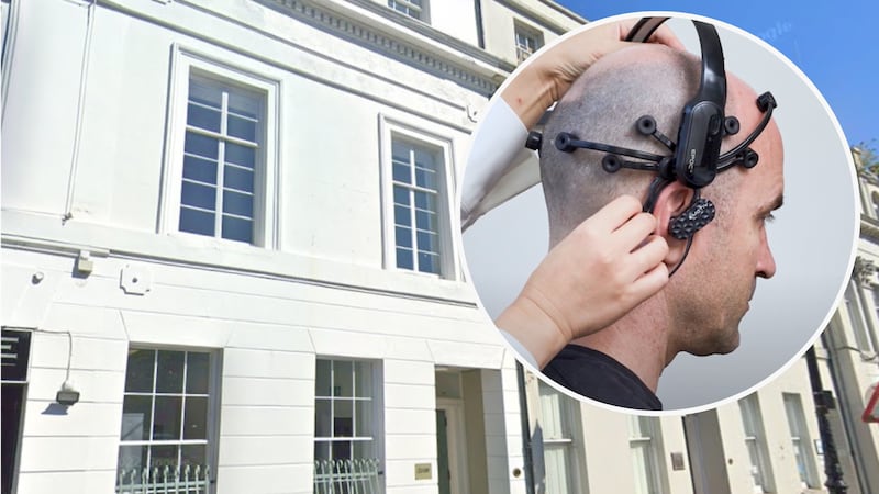 A picture taken from the street of a listed building, with a second image inset, showing a man from behind wearing a headset.