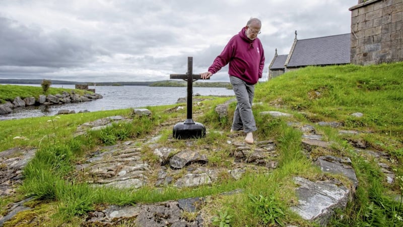 Fr La Flynn, the Prior of Lough Derg, pictured praying at St Patrick&#39;s Purgatory&#39;s penitential beds last year. Yesterday he started a lone vigil on the island for the second year in a row, as Covid restrictions mean pilgrims are still not able to return to the site. Picture by Paul Faith/AFP 