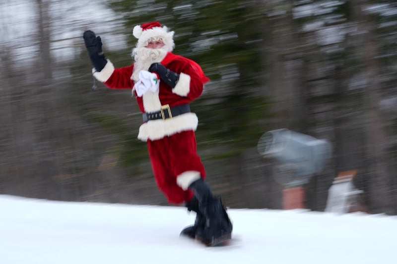 A skier dressed as Santa Claus skis for charity at the Sunday River Ski Resort in Newry, Maine 