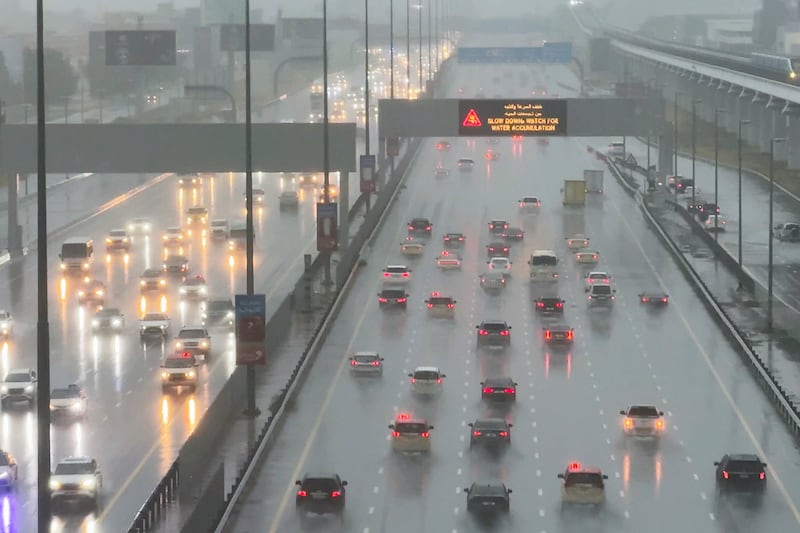 Vehicles drive through heavy rain on the Sheikh Zayed Road highway in Dubai (Jon Gambrell/AP)