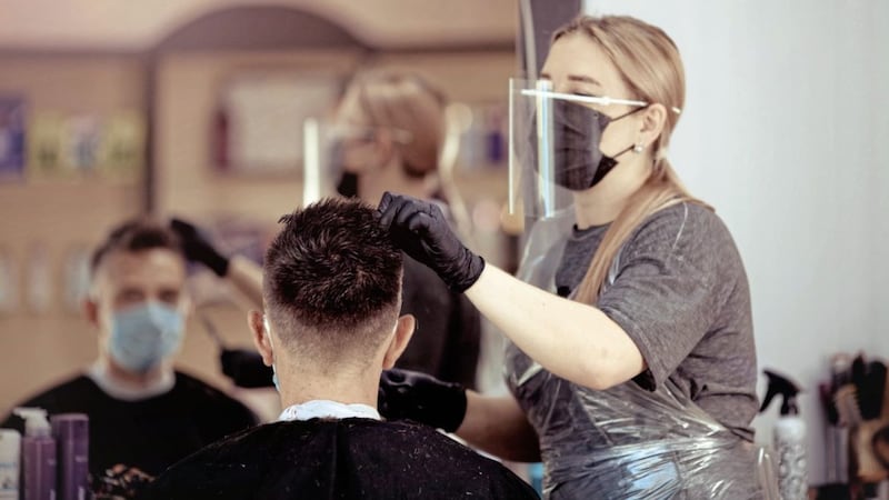 This hairdresser is wearing both a face mask and face shield although UK government guidance only specifies a face shield, scientists advising the government say 
