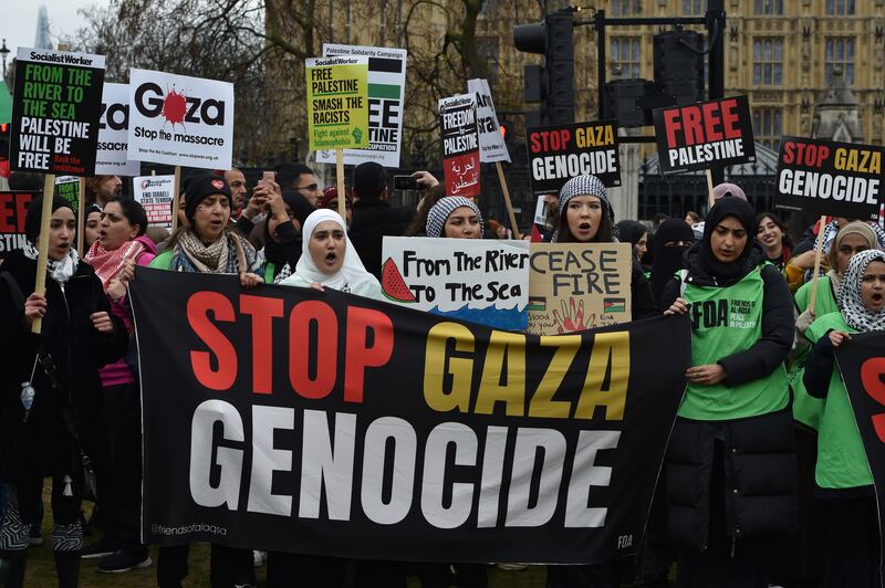 Pro-Palestinian protesters hold banners and placards ahead of a march in support of the Palestinian people in Gaza in London (Thomas Krych/AP)