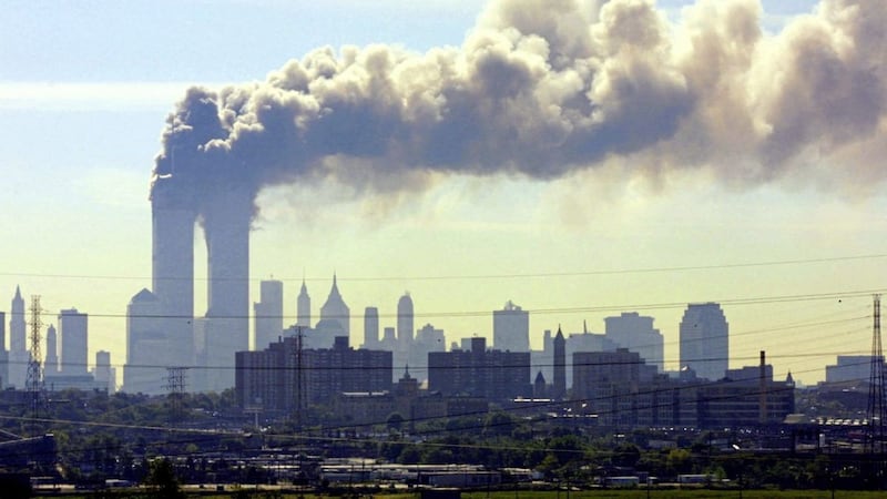Smoke billows from the twin towers of the World Trade Center in New York after planes crashed into both towers on September 11, 2001. (AP Photo/Gene Boyars). 
