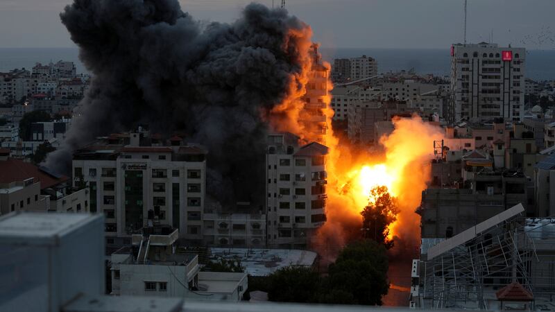 A ball of fire and smoke rises from an explosion on a Palestinian apartment tower following an Israeli air strike in Gaza City (Adel Hana/AP)