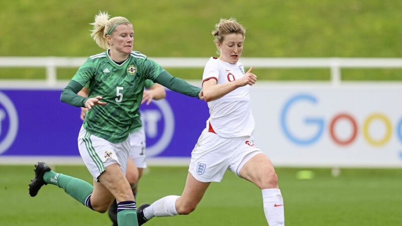 Julie Nelson of Northern Ireland chases Ellen White of England during the recent friendly. 