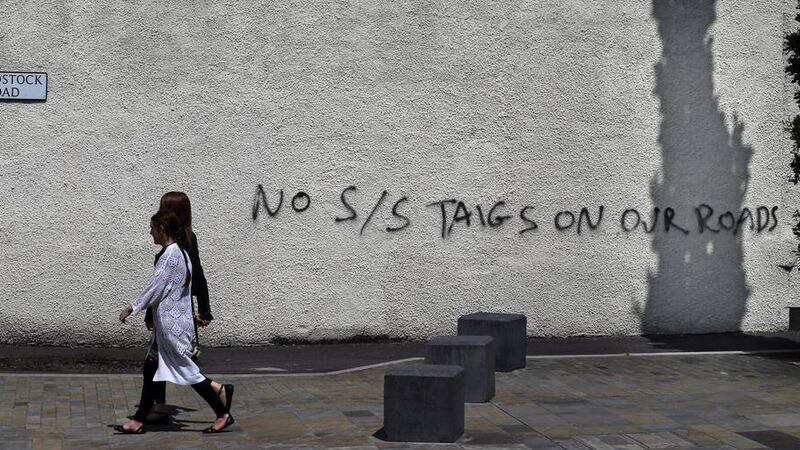The scene at Belfast's Woodstock Road yesterday showing sectarian graffiti warning Catholics to stay out of loyalist areas. Picture Hugh Russell.