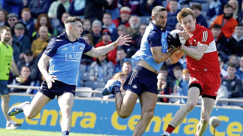Dublin&#39;s James McCarthy and Derry&#39;s Brendan Rogers compete for possession during the 2023  Division Two final