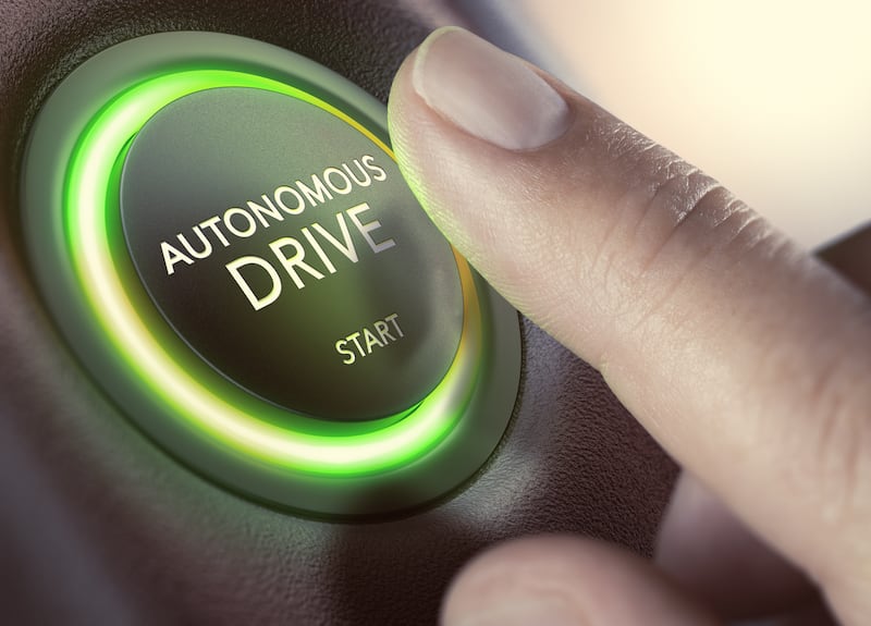 Finger ready to press start button on autonomous drive vehicle (Olivier Le Moal/Getty Images)