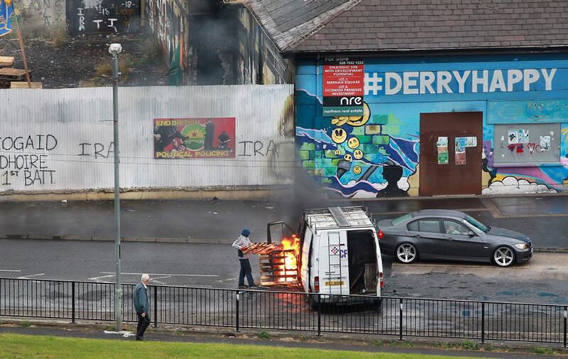 A man sets fire to a van during riots in Derry's Bogside last week. Picture by Margaret McLaughlin