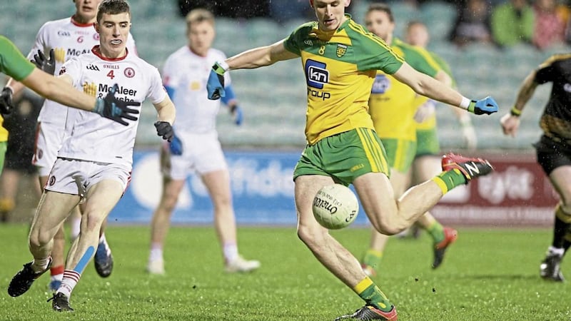 Donegal&#39;s top scorer on the night, Michael Langan, strikes for a point as Conor Shields of Tyrone closes in 