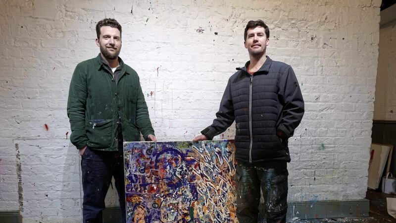 Artists Niall Conlon and Paul Doran with one of their collaboration paintings, Solutions for the People. They have created a series of artworks and worked with WAVE Trauma Centre and Queen&#39;s University medical students for the Minding Minds Together mental health project. Picture by Mal McCann 