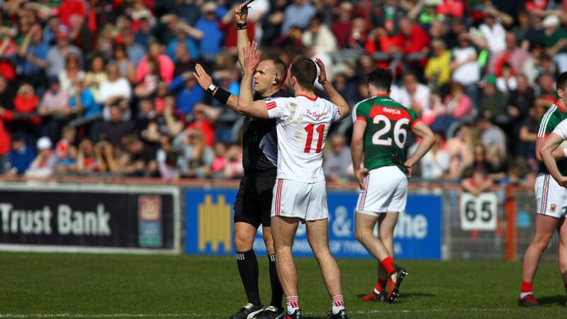 Referee Conor Lane gives Niall Sludden a black card during Tyrone&rsquo;s Division One loss to Mayo in Omagh on Sunday &ndash; yet another controversial application of the rule. Picture by Seamus Loughran&nbsp;