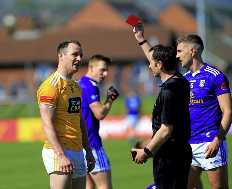 Michael McCann gets a red card from referee Jerome Henry Picture: Seamus Loughran. 