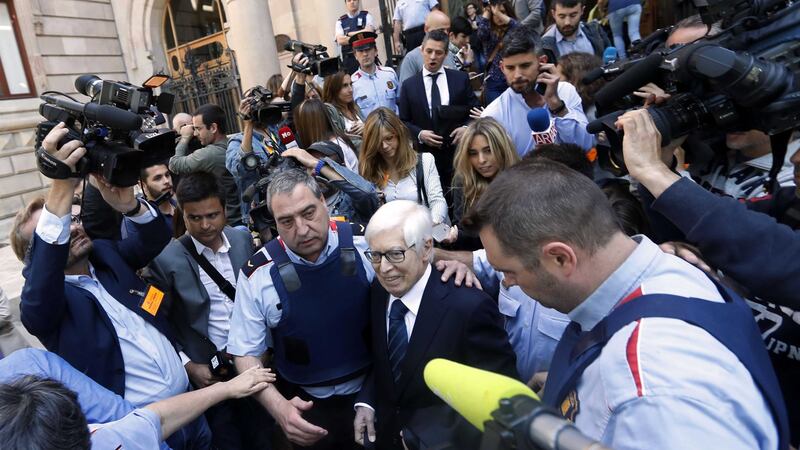 Lionel Messi's lawyer Enrique Bacigalupo, centre right, is surrounded by journalists on leaving a court in Barcelona, Spain. Picture by Manu Fernandez, Associated Press&nbsp;