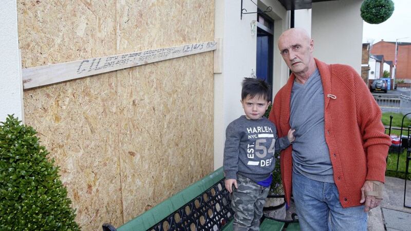 James Murtagh with his son Morgan (4) shows the damage caused to his home when a rock was thrown at his window in Ravenhill Avenue in east Belfast. Picture by Mal McCann. 