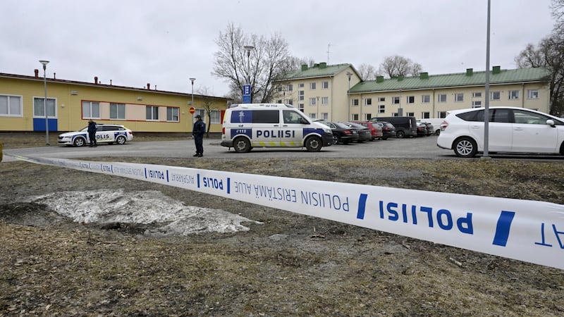 Police officers stand guard outside the school in Finland (Markku Ulander/Lehtikuva via AP)