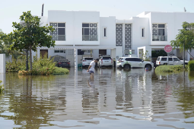 A man walks through floodwater in the Mudon (AP)