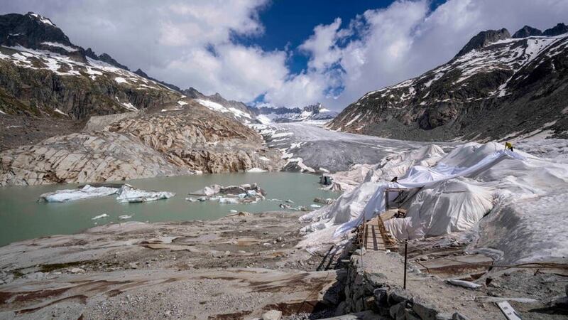 Chunks of ice float in a lake in front of the Rhone Glacier (Matthias Schrader/AP)