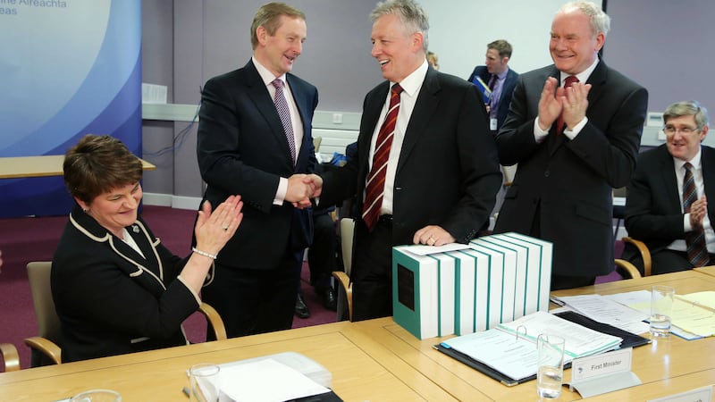 Taoiseach Enda Kenny presents the First Minister Peter Robinson with nine volumes of the Dictionary of Irish Biography during a meeting of the North South Ministerial Council in Armagh as Deputy First Minister Martin McGuinness, Finance Minister Arlene Foster and Education Minister John O'Dowd look on. Picture by&nbsp;Kelvin Boyes, Press Eye, PA