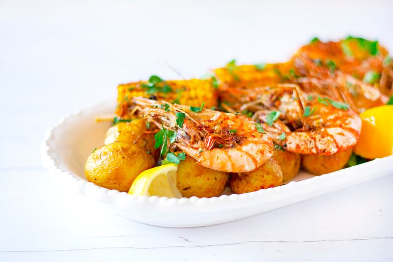 Cajun prawns with potato and corn