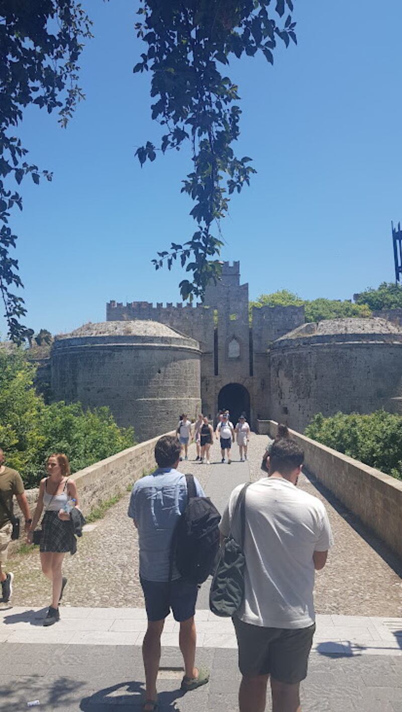 Crossing the dry moat, now a public park, on the way into the historic Rhodes old town