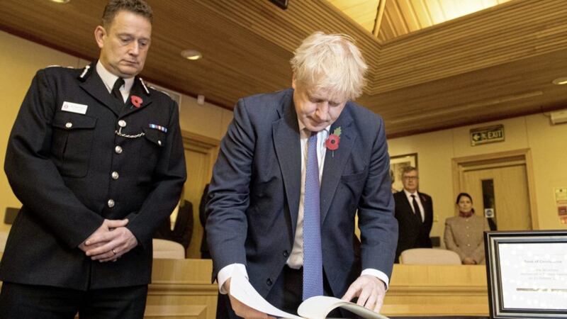 Prime Minister Boris Johnson signs a book of condolence, watched by the Chief Constable of Essex Police, Ben-Julian Harrington, during a visit to Thurrock Council Offices in Essex after the bodies of 39 people were found in a lorry container last week. Picture by Stefan Rousseau, Press Association 