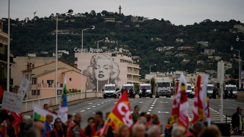 Demonstrators protest against Emmanuel Macron’s pension reform in Cannes (Daniel Cole/AP)