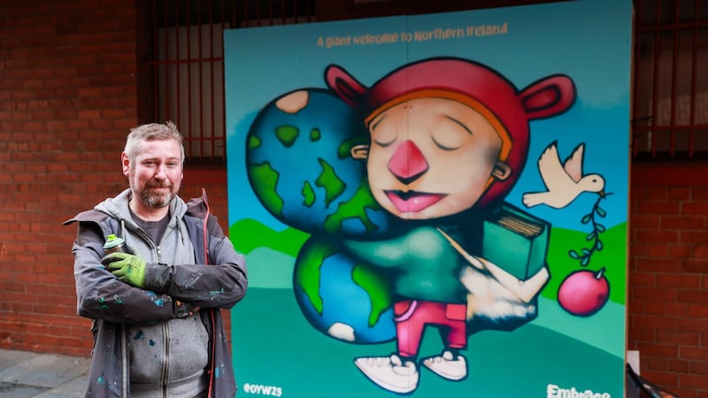 Artist Kevin Largey outside the Oh Yeah Music Centre, with his artwork commissioned by Tourism Northern Ireland for One Young World 2023 Belfast Summit. Picture date: Tuesday October 3, 2023. PA Photo. See PA story ULSTER Youth. Photo credit should read: Liam McBurney/PA Wire