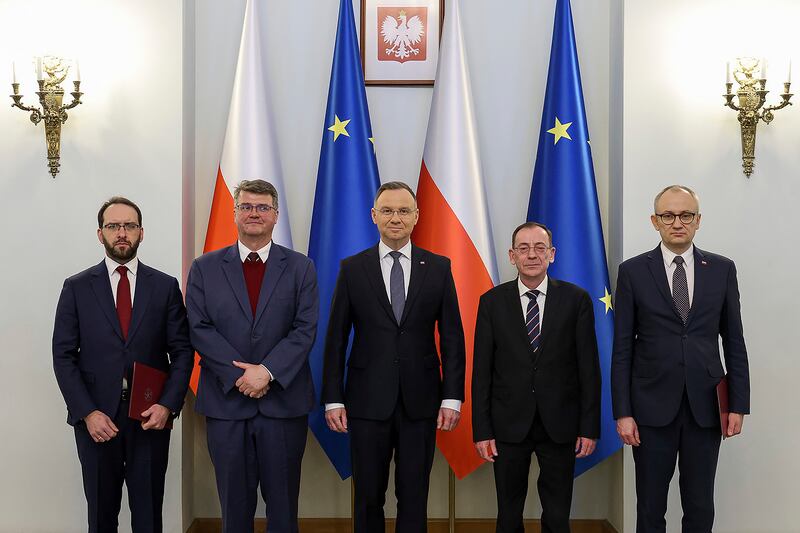 President Andrzej Duda, centre, with Stanislaw Zaryn, Maciej Wasik, Mariusz Kaminski and Blazej Pobozy (President Palace/Jakub Szymczuk/AP)