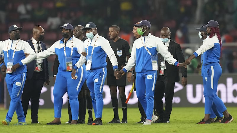 Referee Bamlak Tessema of Ethiopia, center, and his officials are shielded by security personnel at the end of the African Cup of Nations 2022 round of 16 soccer match between Cameroon and Comoros at the Olembe stadium in Yaounde, Cameroon. (AP Photo/Themba Hadebe)<br />&nbsp;