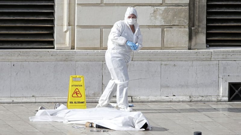               Investigative police officers works by a body under a white sheet outside Marseille &#39;s main train station Sunday, Oct. 1, 2017 in Marseille, southern France. A man with a knife attacked people at the main train station in the southeastern French city of Marseille on Sunday, killing two women before soldiers fatally shot the assailant, officials said. (AP Photo/Claude Paris)             
